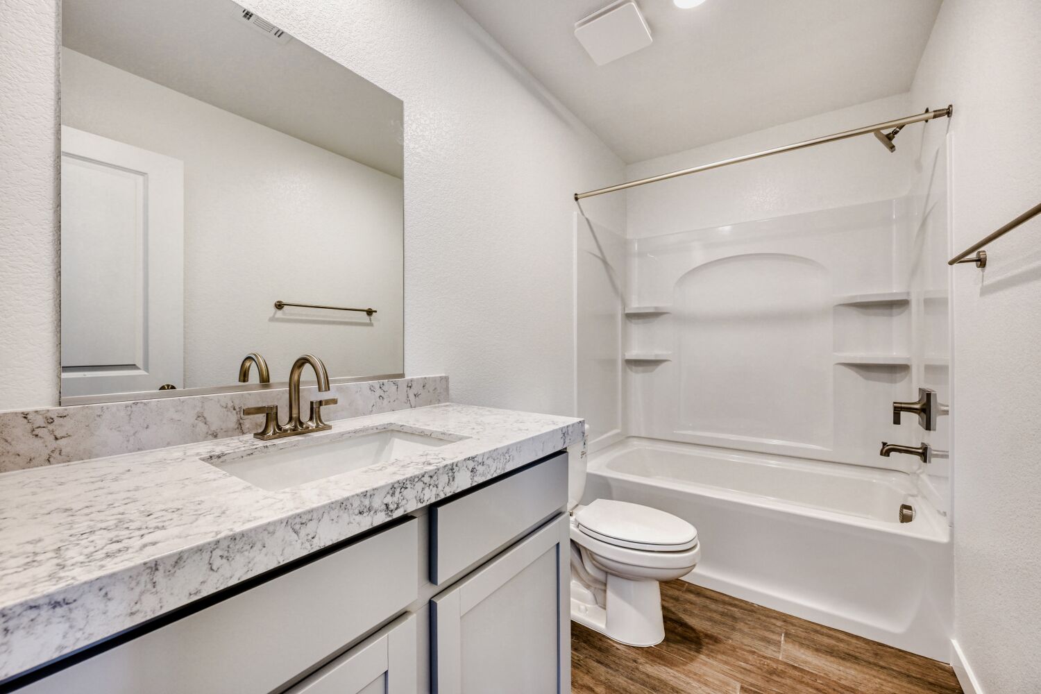 A bathroom with a tub sink and toilet.