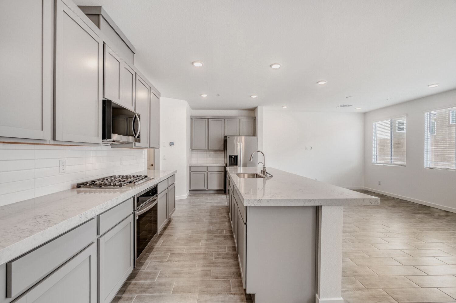 A kitchen with white cabinets.