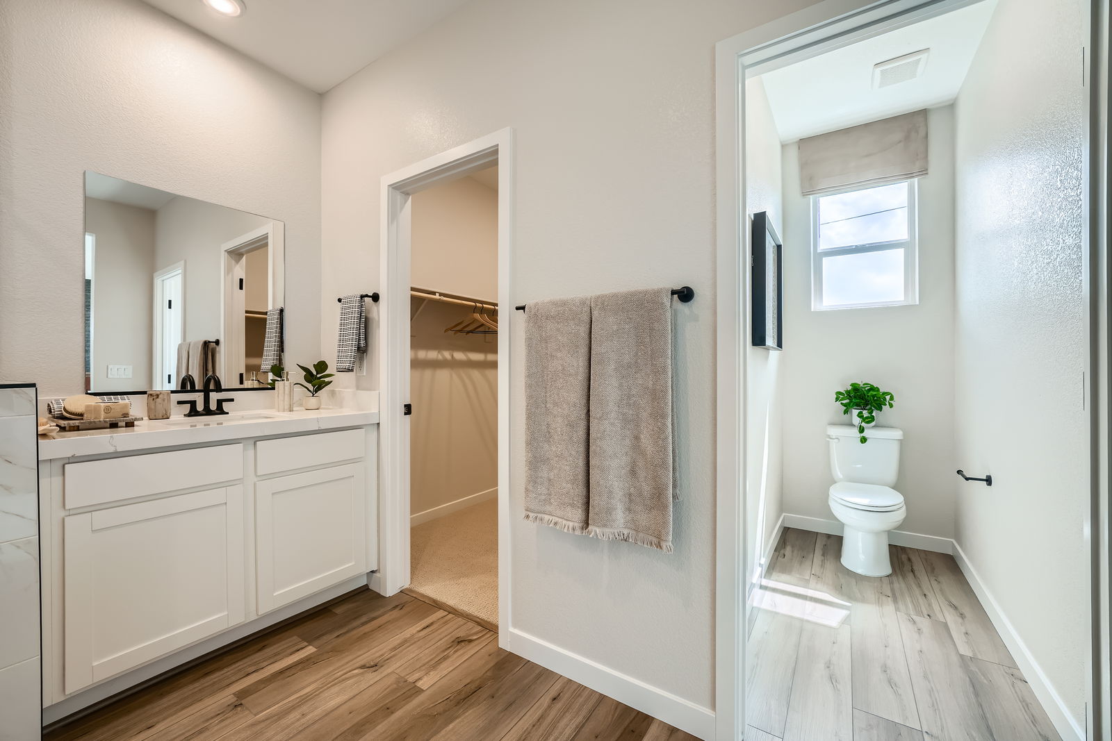 A bathroom with white cabinets.