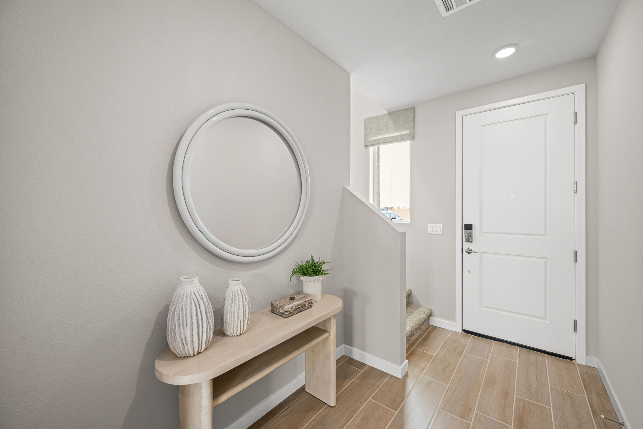 A room with a mirror and a table.