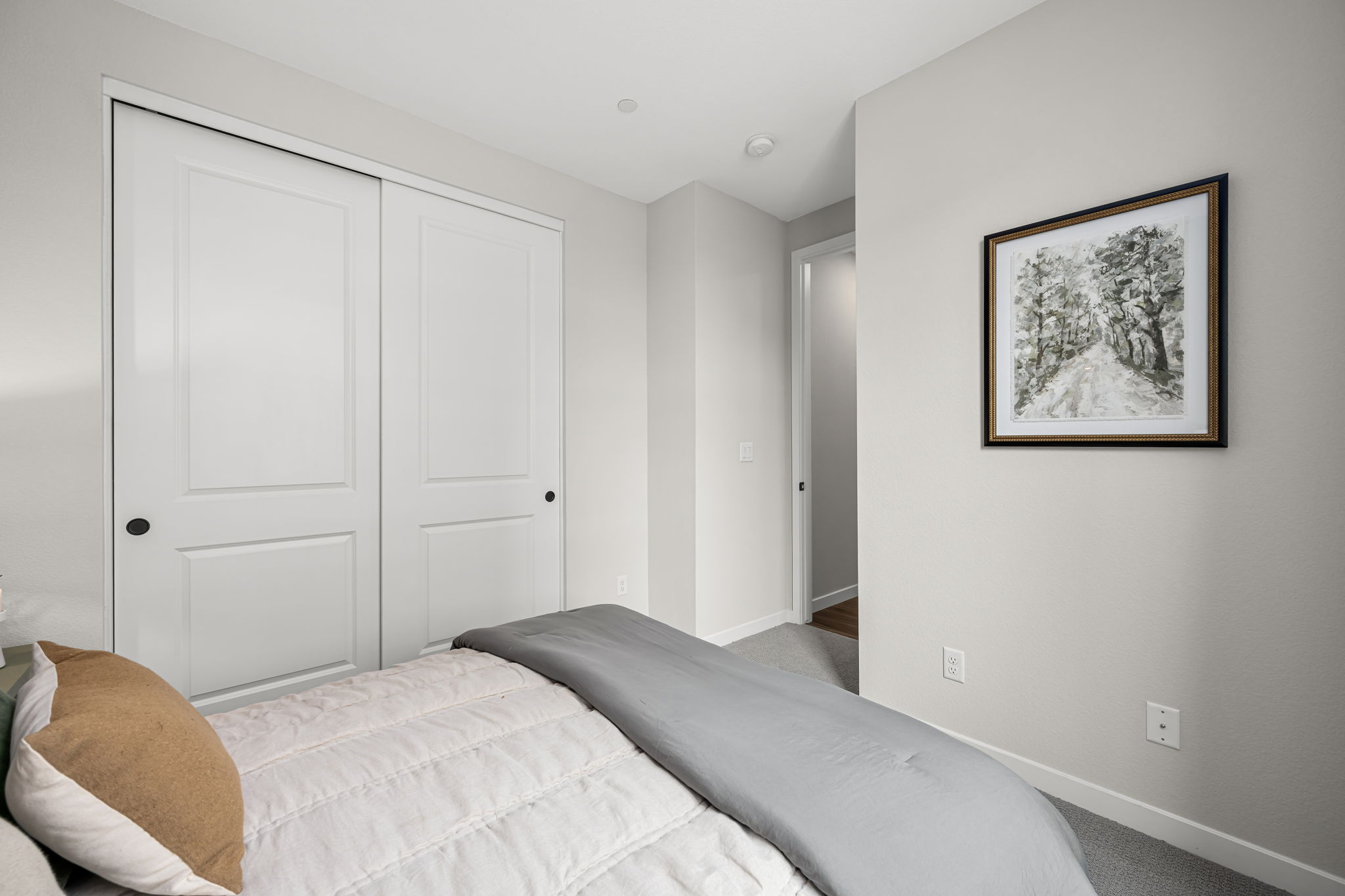 A bedroom with white doors.