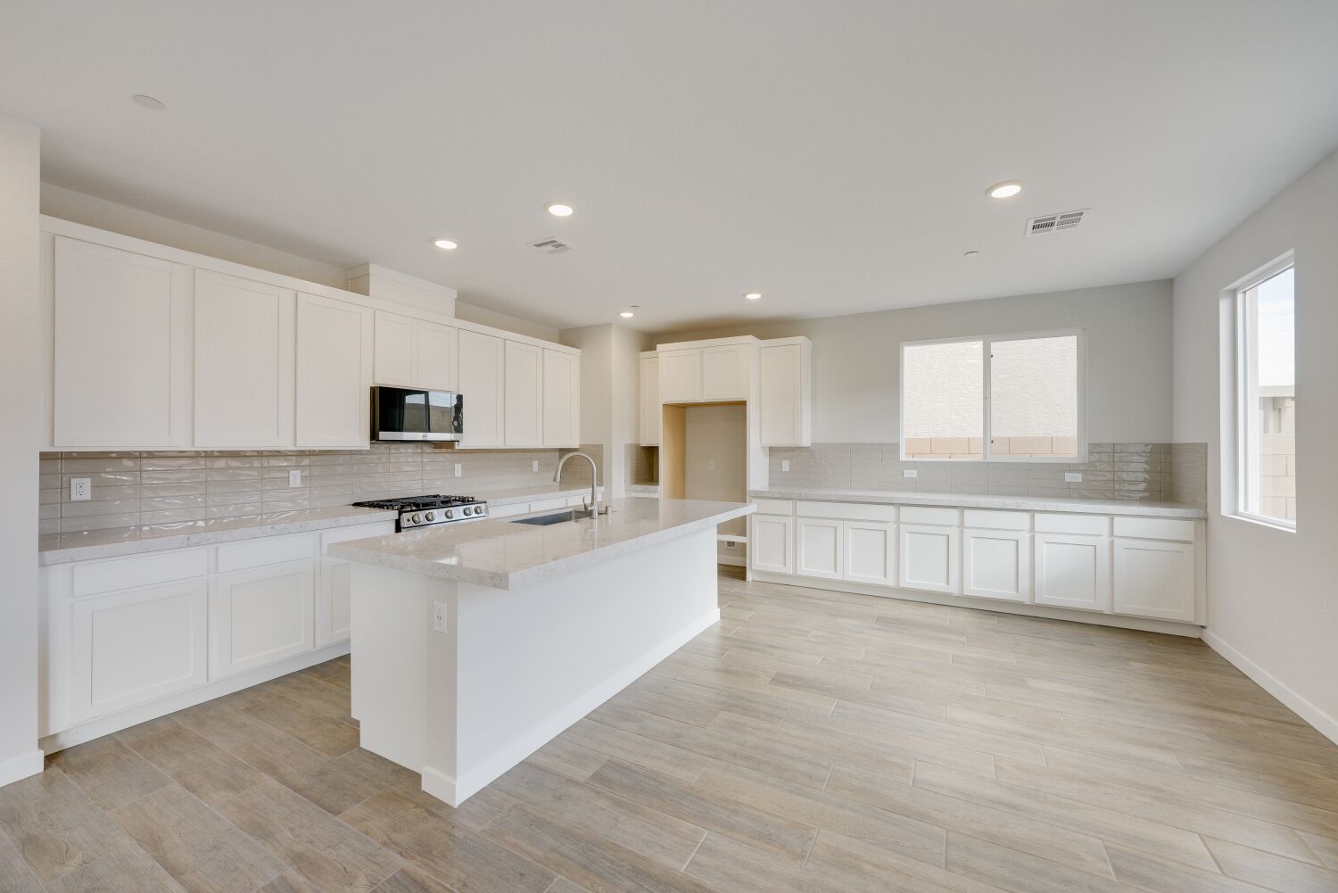 A kitchen with white cabinets.