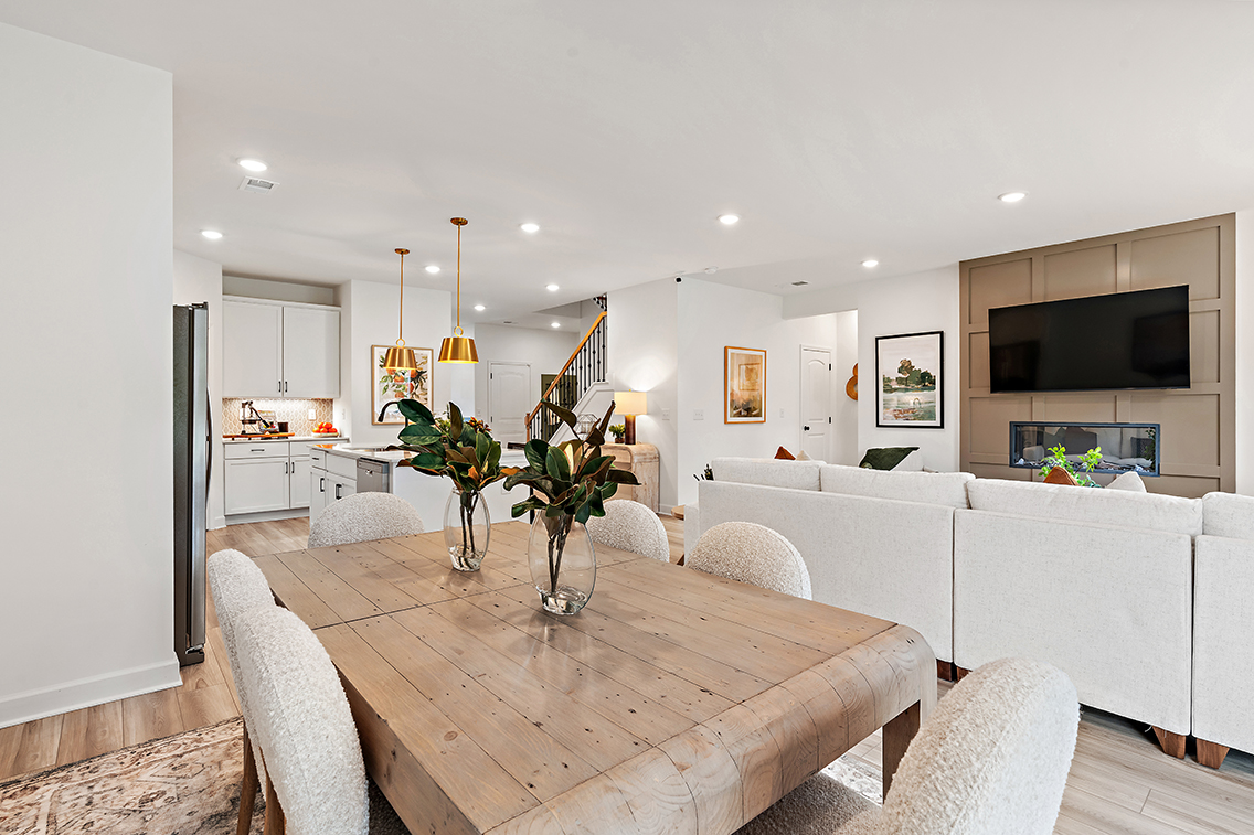 A living room with a large table and a couch.