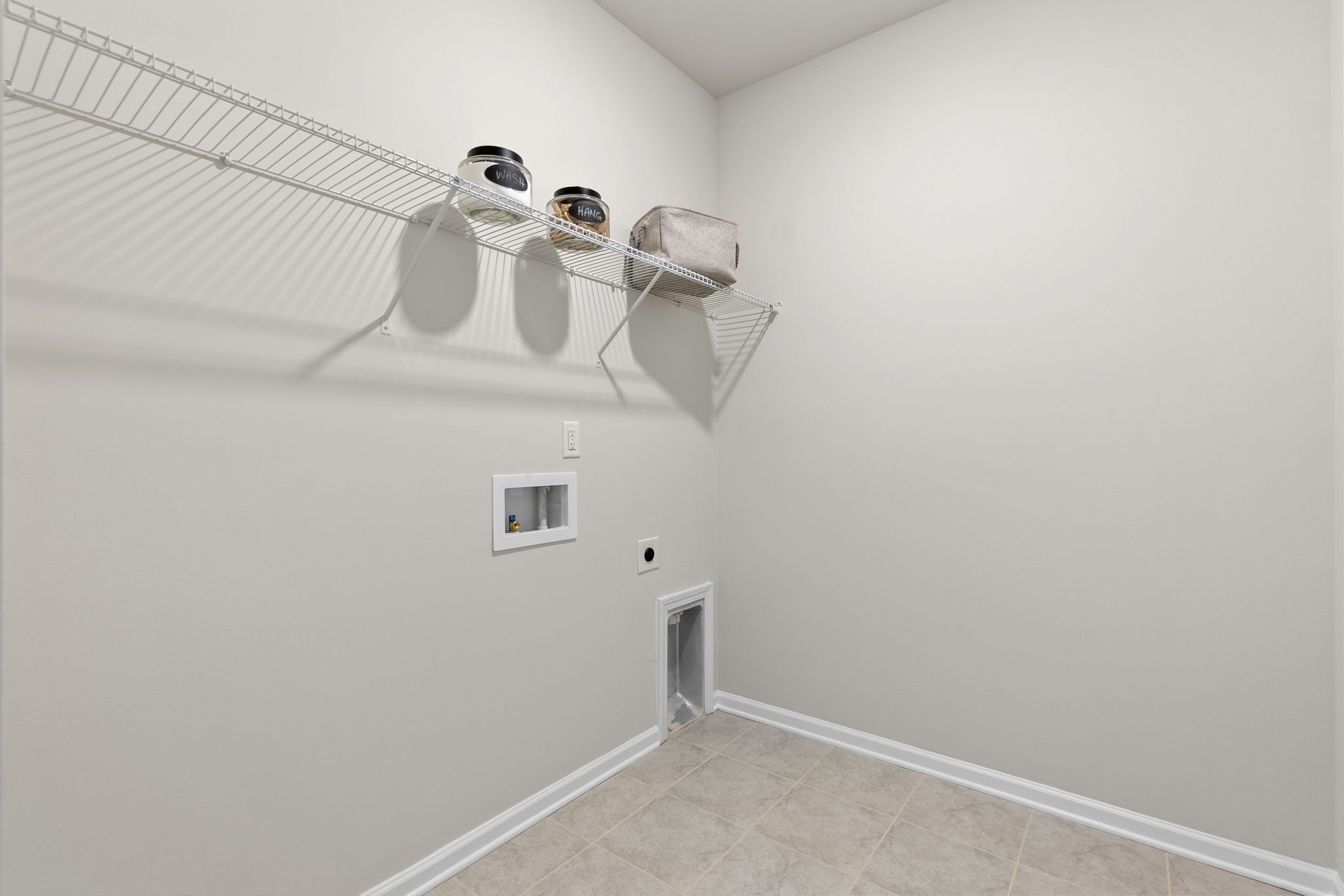 A white room with a light from the ceiling.