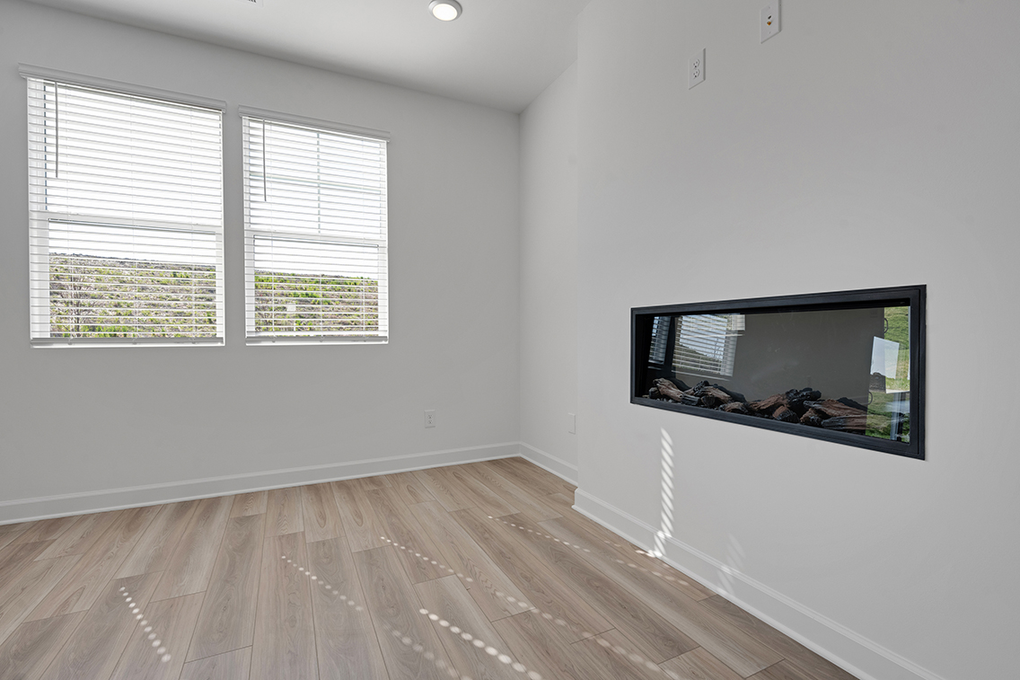 A room with a tv and a wood floor.