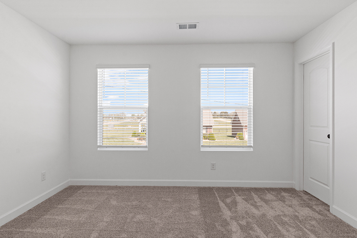 A room with a window and a door.