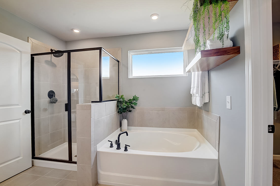 A bathroom with a tub and shower.