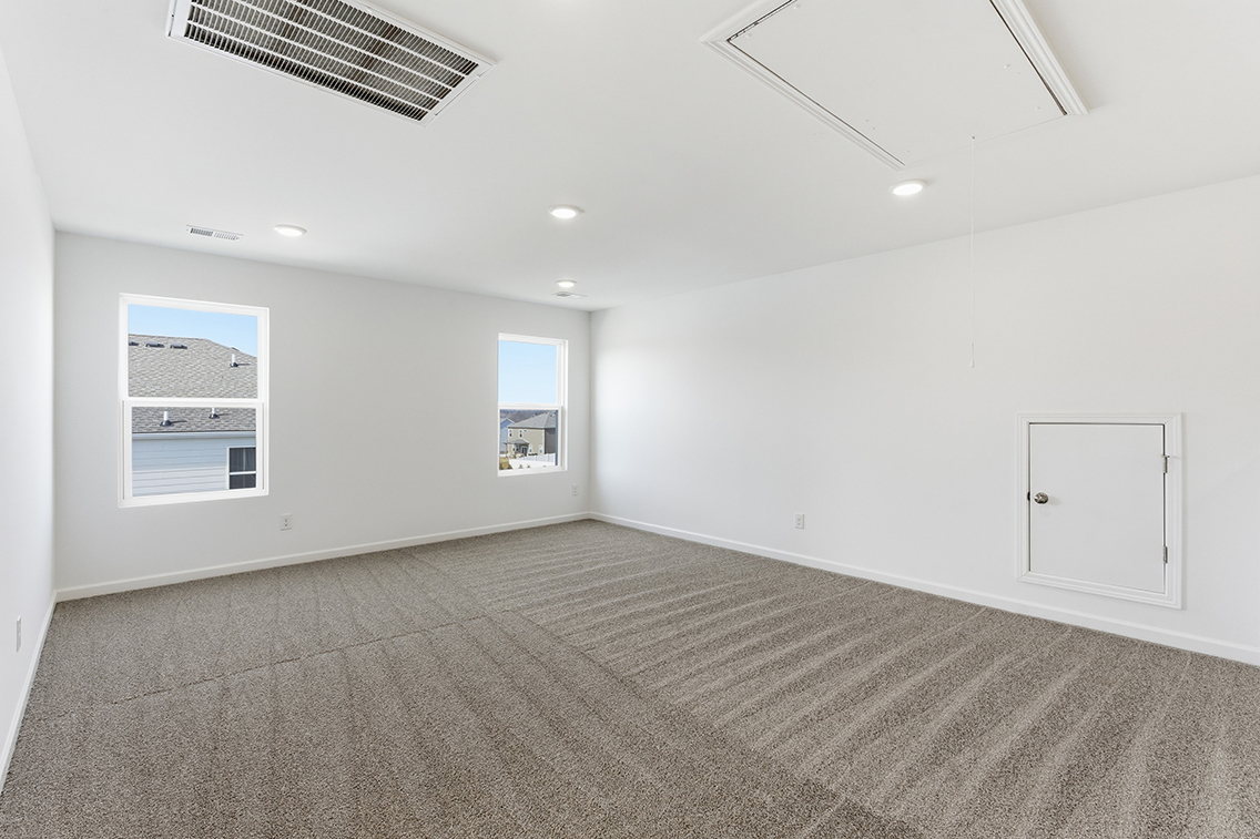 A room with white walls and a carpeted floor.