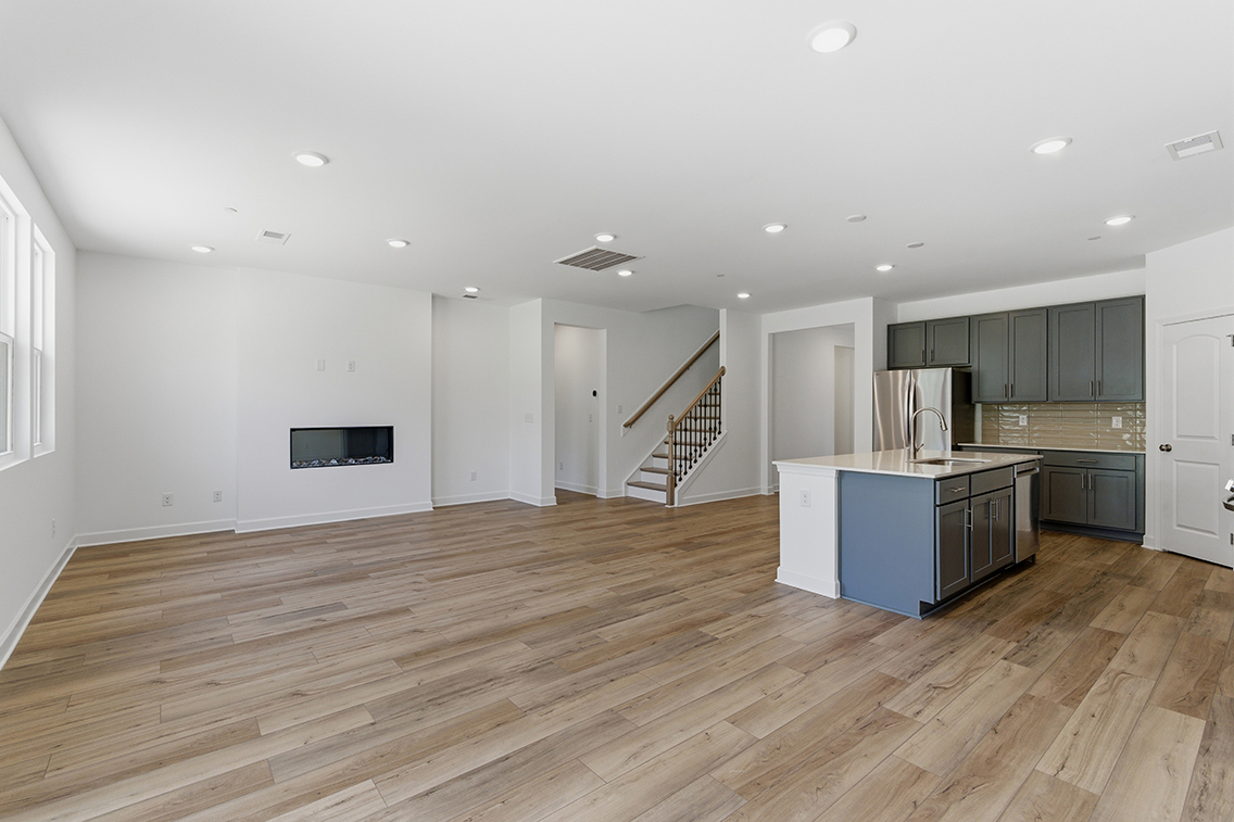 A large kitchen with wood floors.