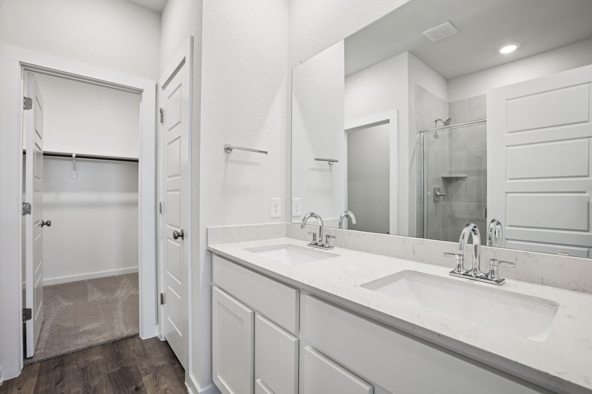 A bathroom with a large mirror.