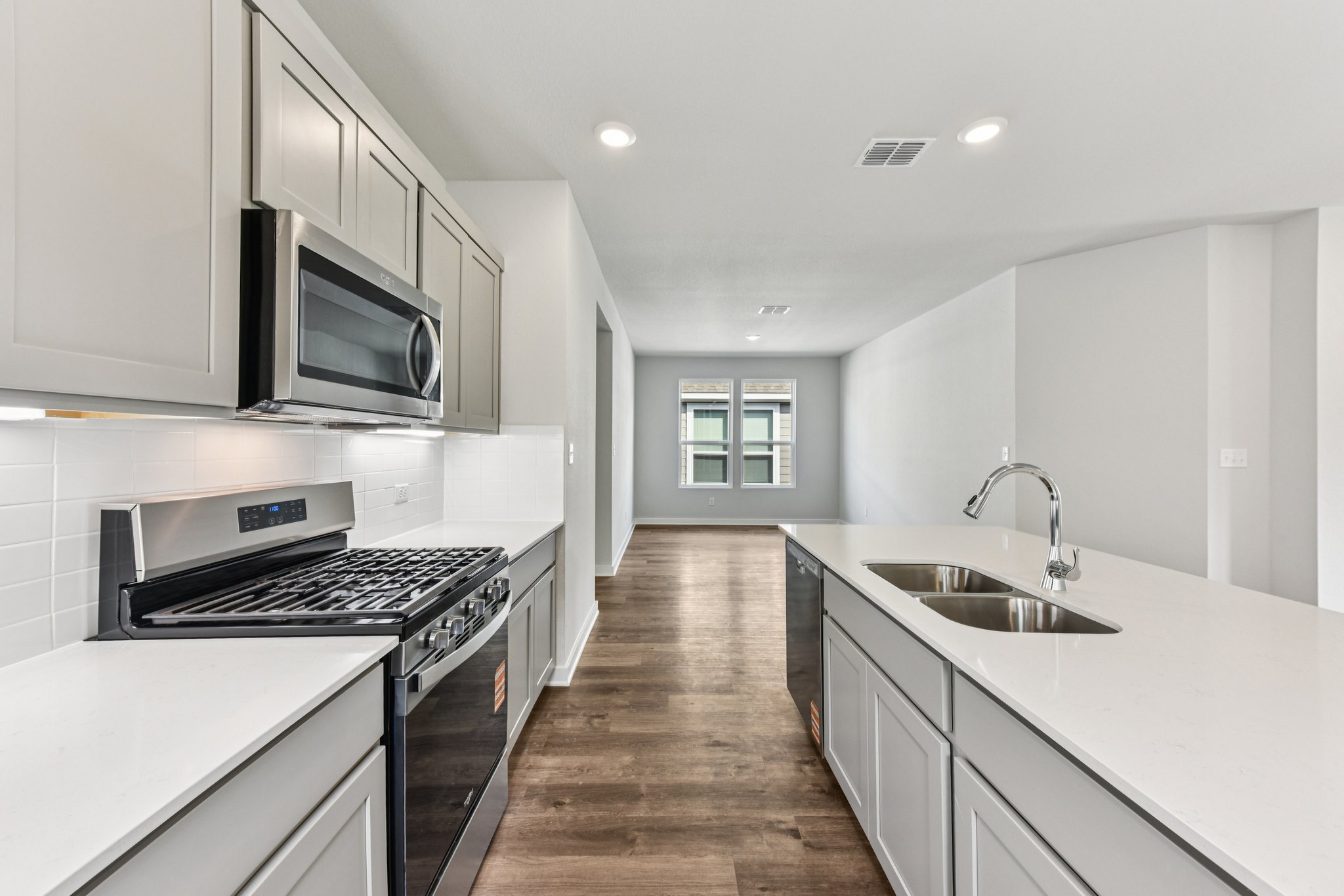A kitchen with white cabinets.