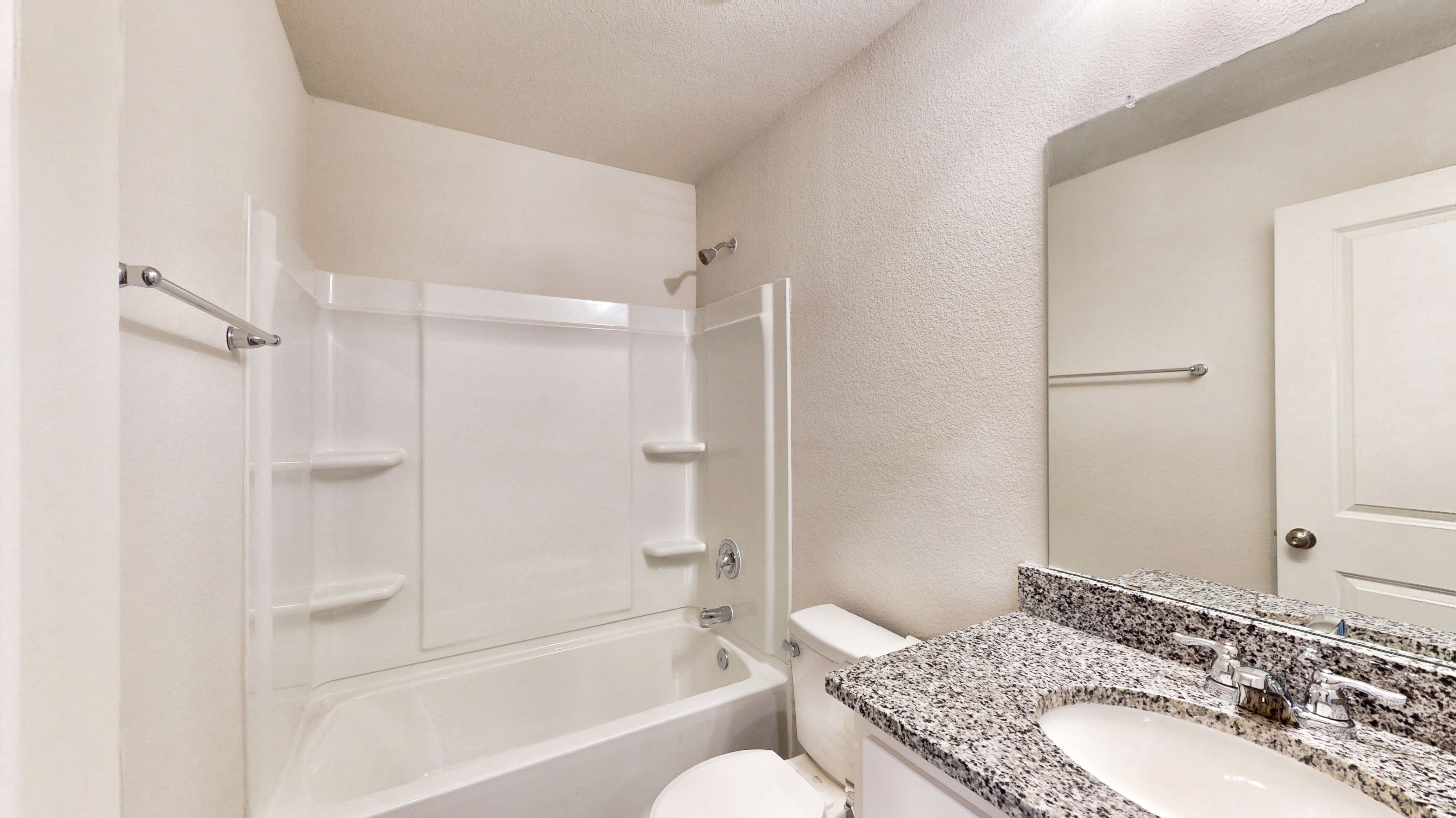 A bathroom with a marble countertop.