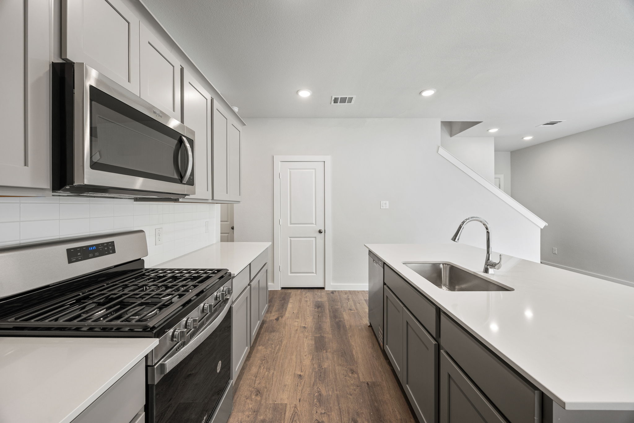 A kitchen with white cabinets.
