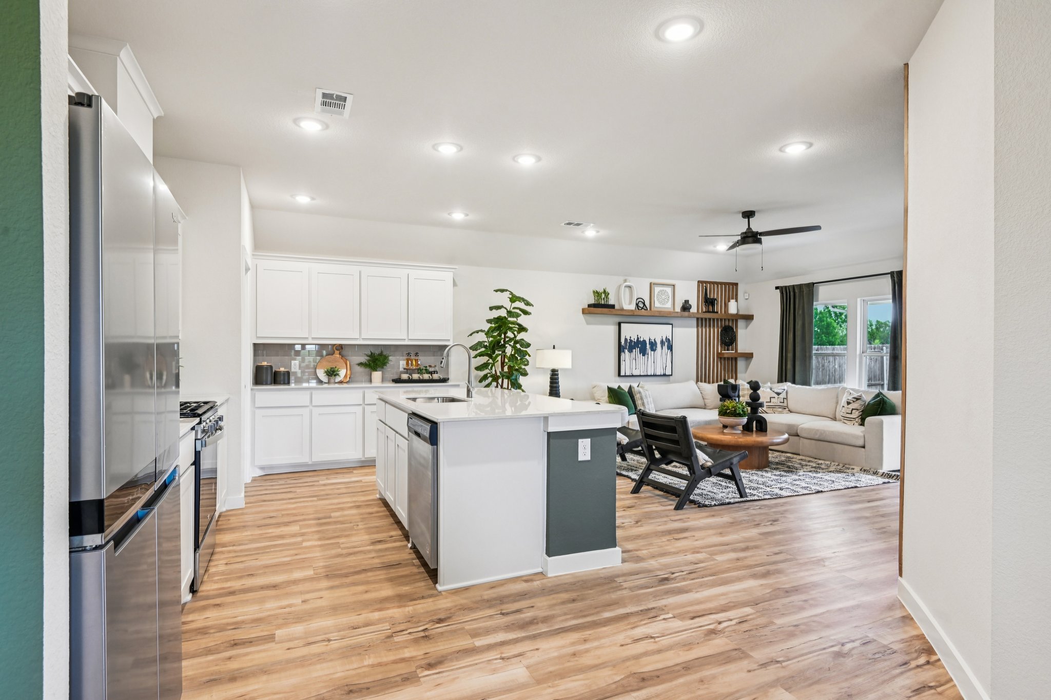 A kitchen with white cabinets.
