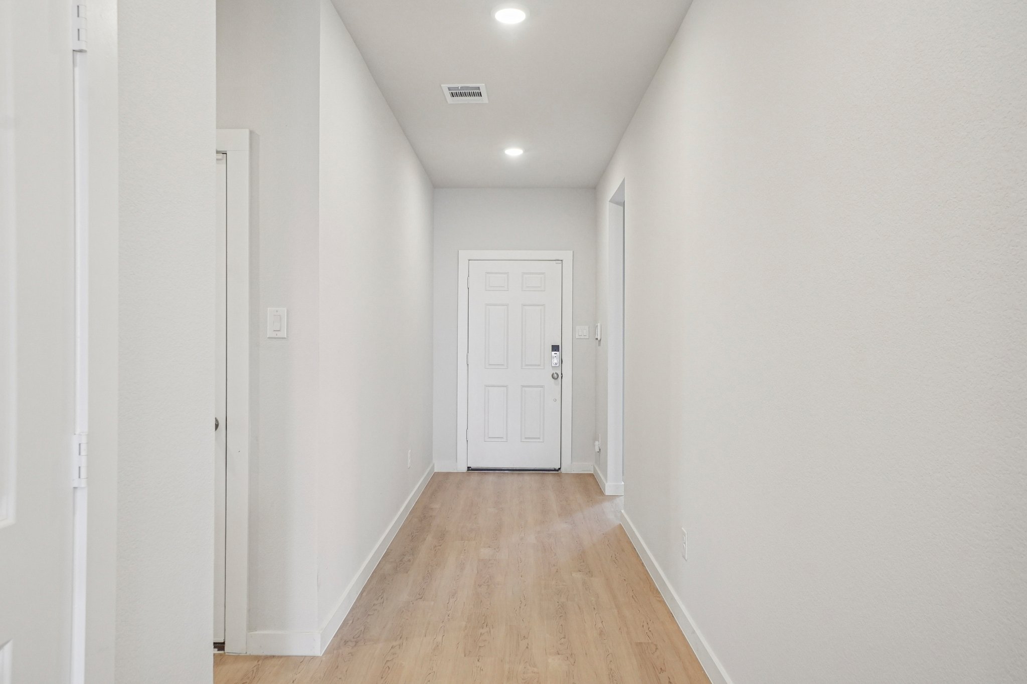A hallway with white doors.