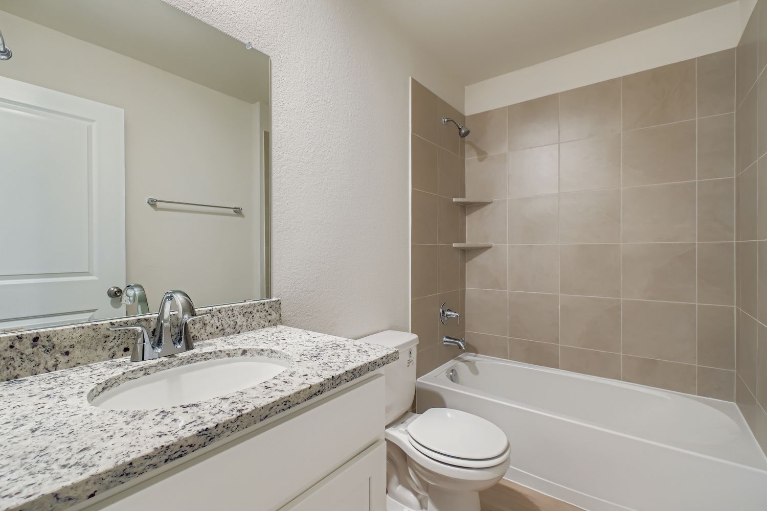 A bathroom with a marble countertop.