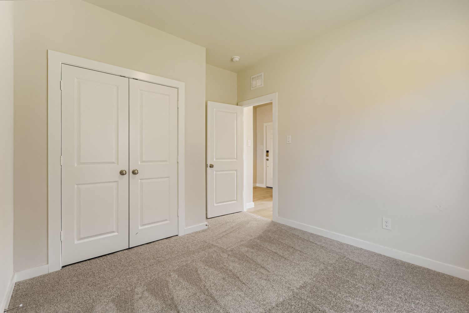 A hallway with white doors.