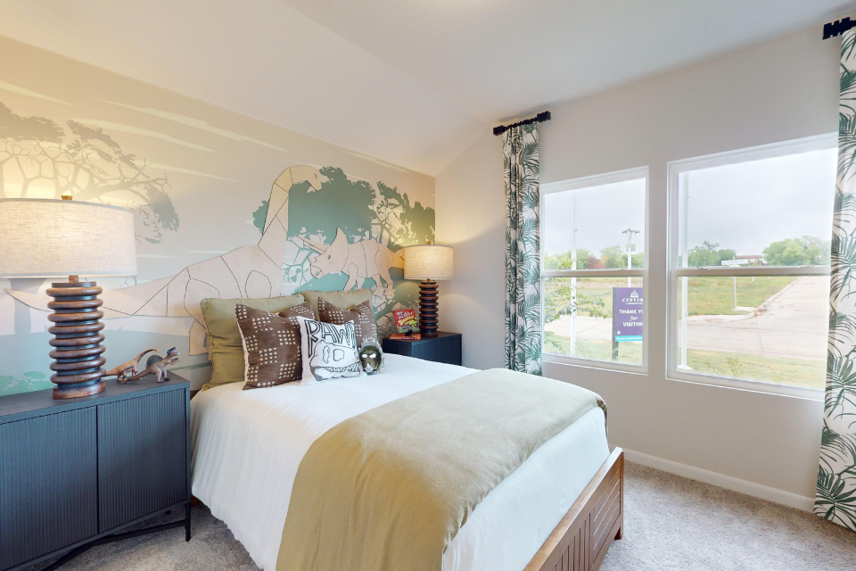 A bedroom with a bed and a window.