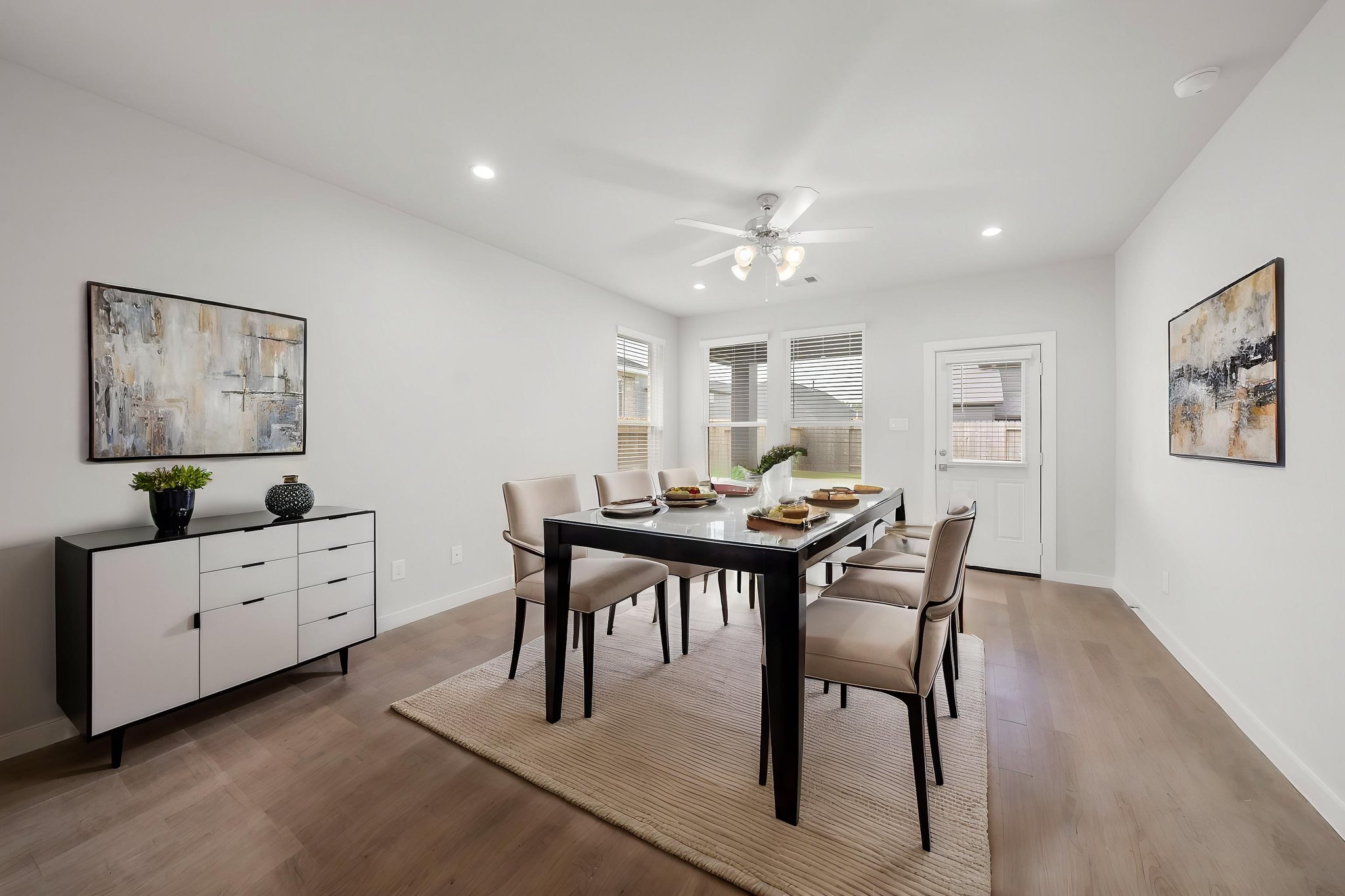 A dining room with a table and chairs.