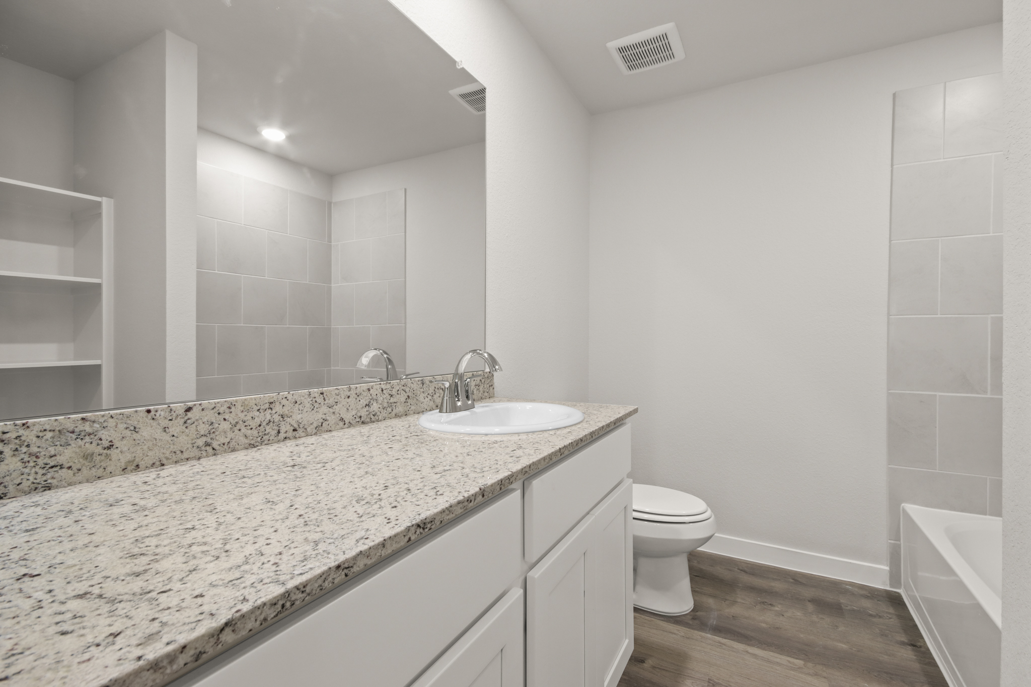 A bathroom with a marble countertop.