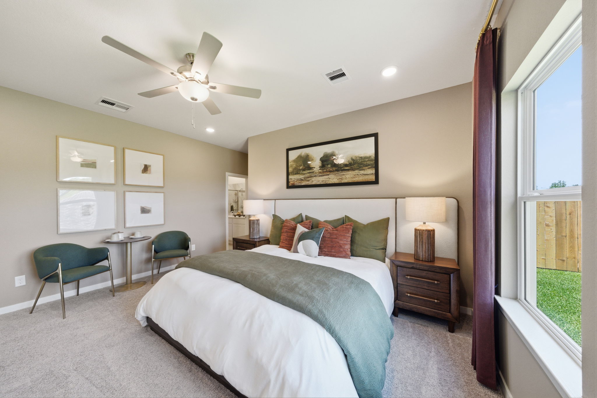 A bedroom with a bed and a fan.