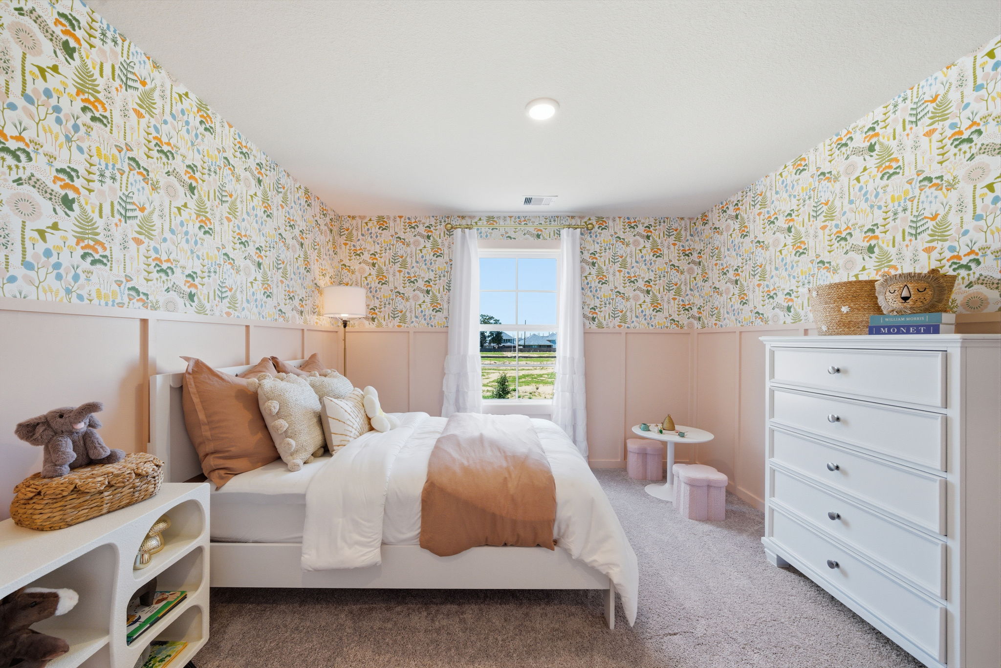 A bedroom with a bed and a dresser.