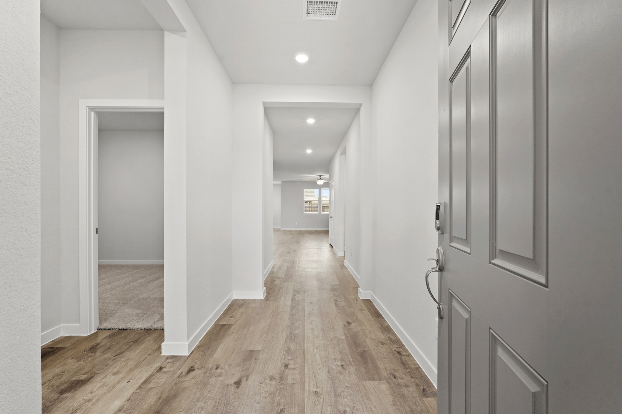 A hallway with white walls.