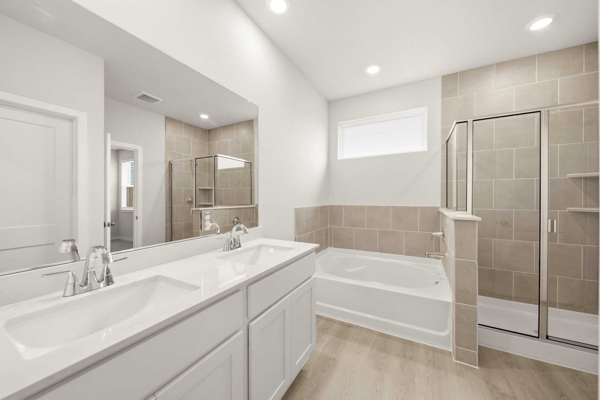 A bathroom with a tub sink and a shower.