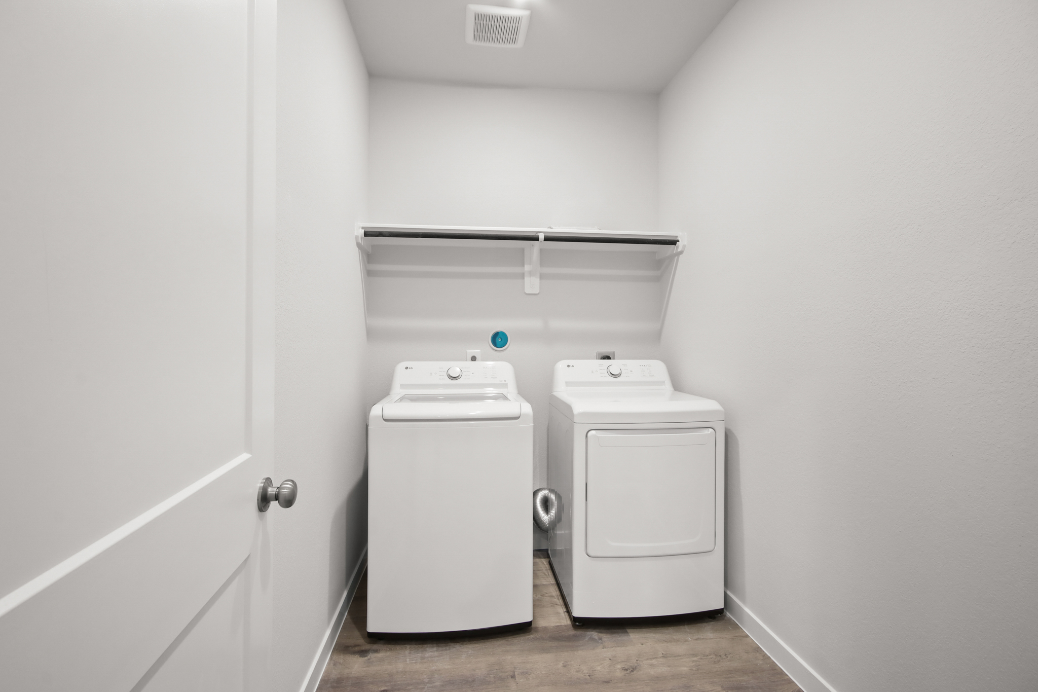 A washing machine in a room.