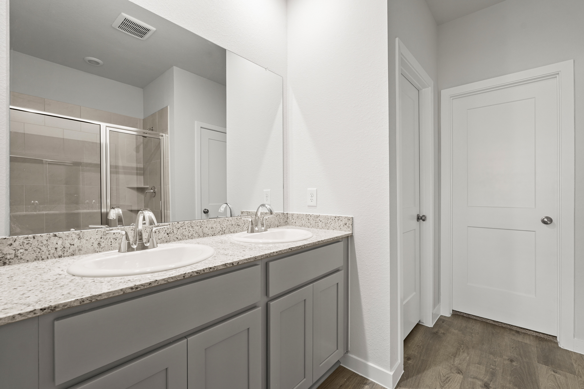 A bathroom with a large mirror.