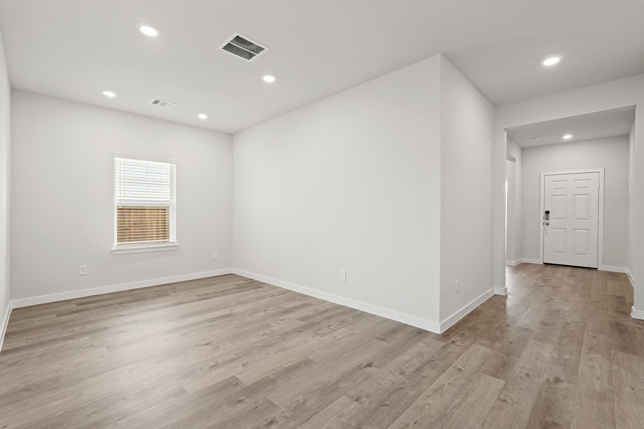 A room with a wood floor and white walls.