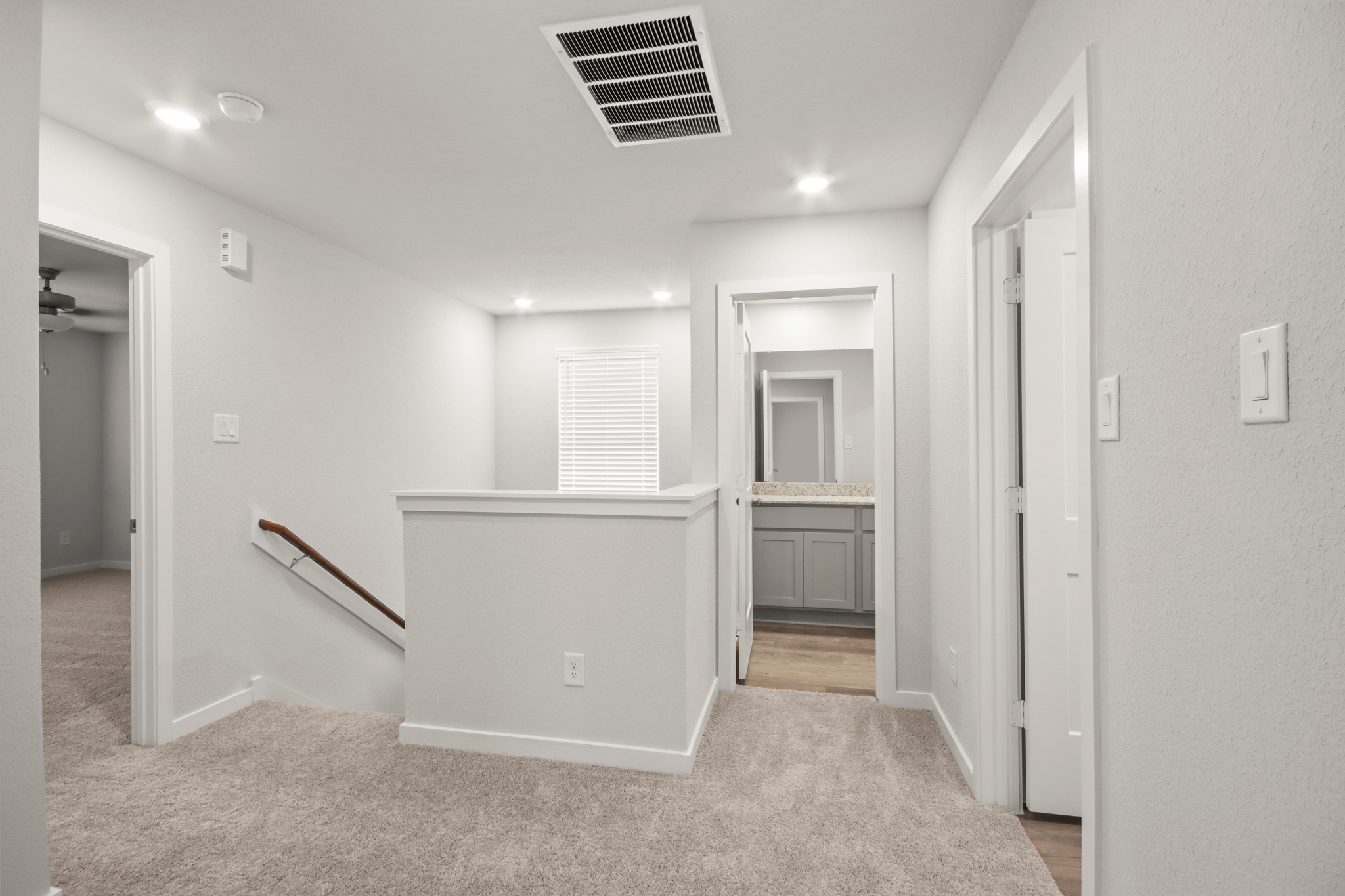 A room with a white wall and a white cabinet.