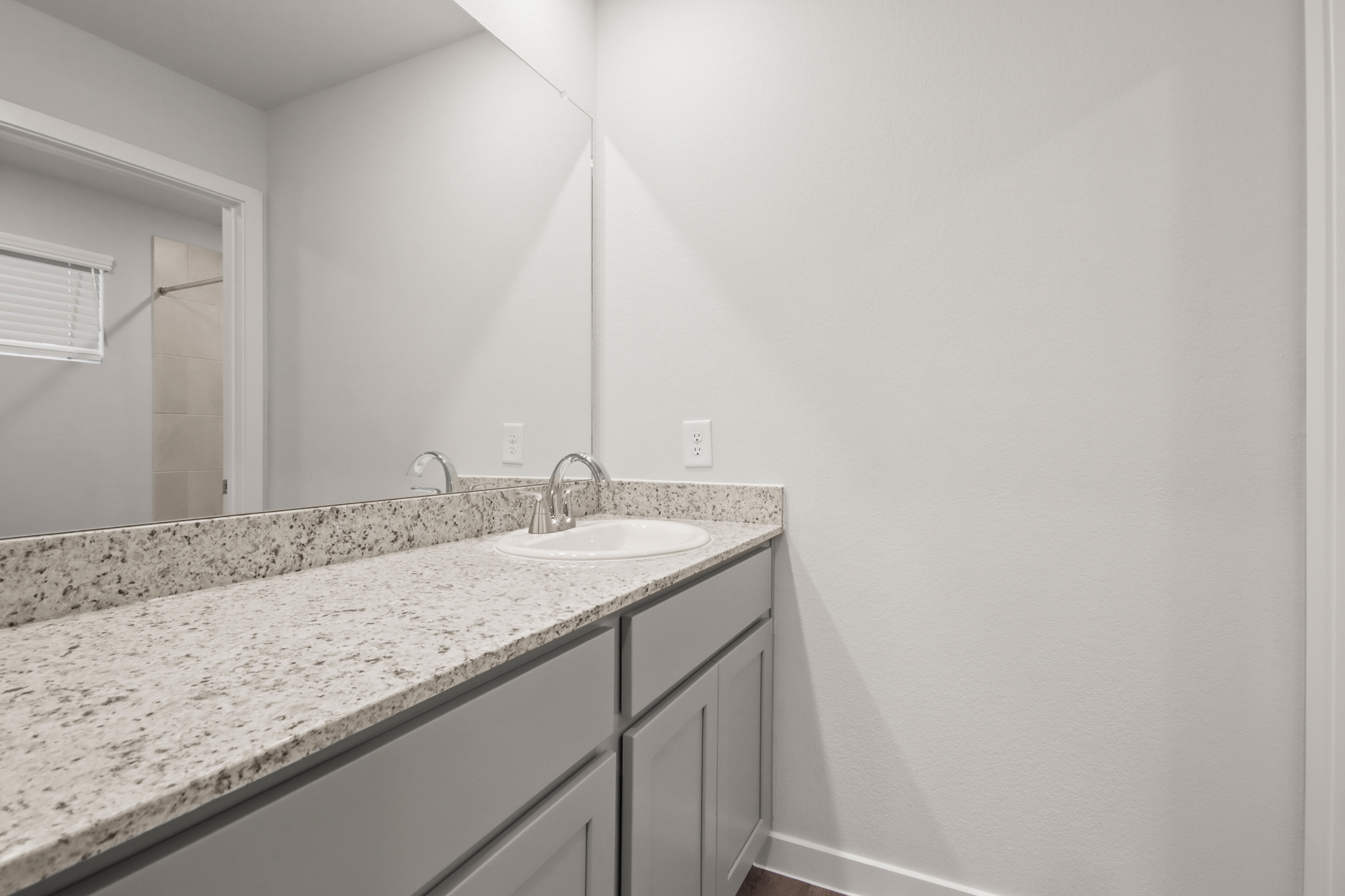 A bathroom with a marble countertop.