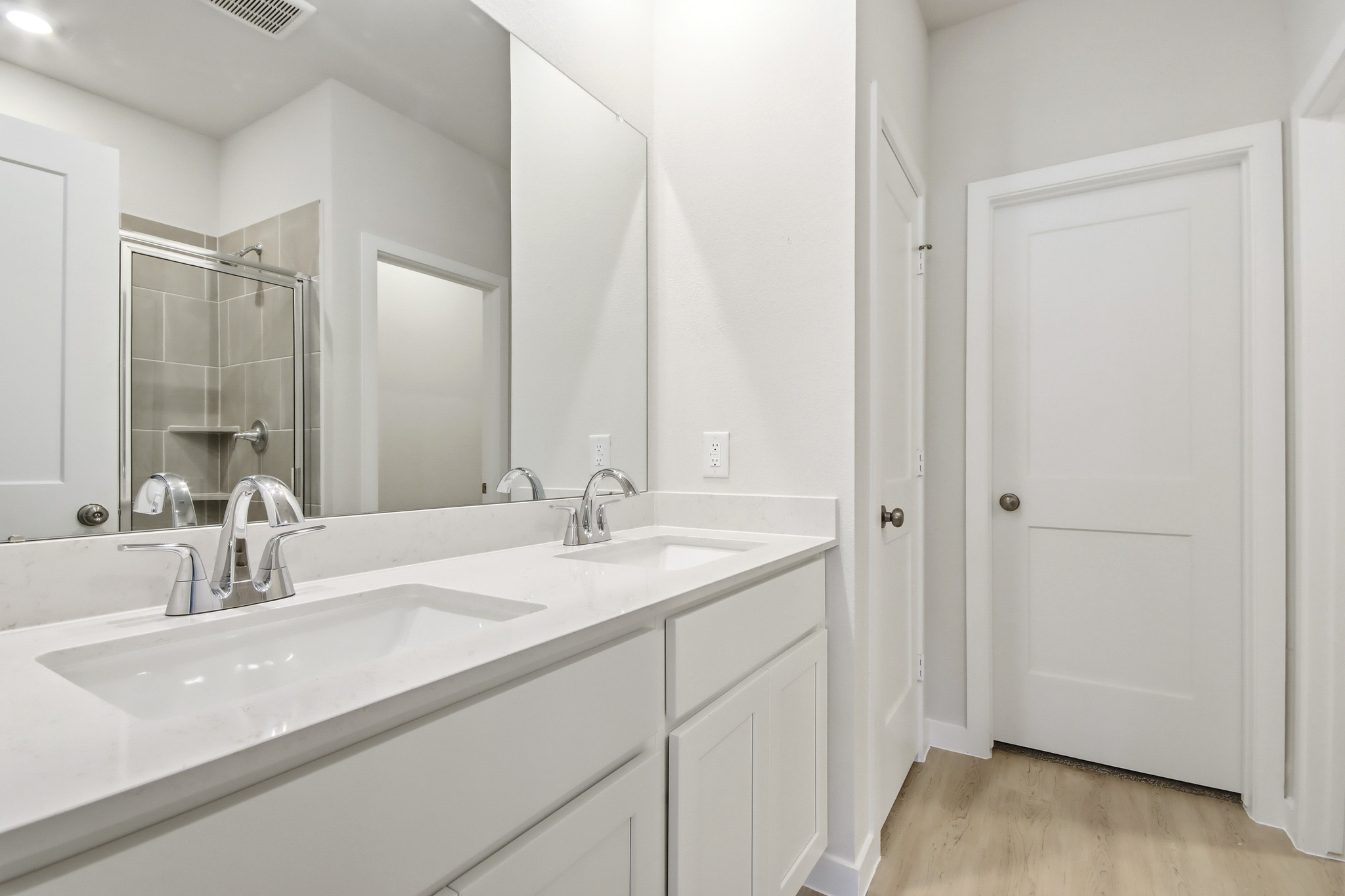 A bathroom with a large mirror.
