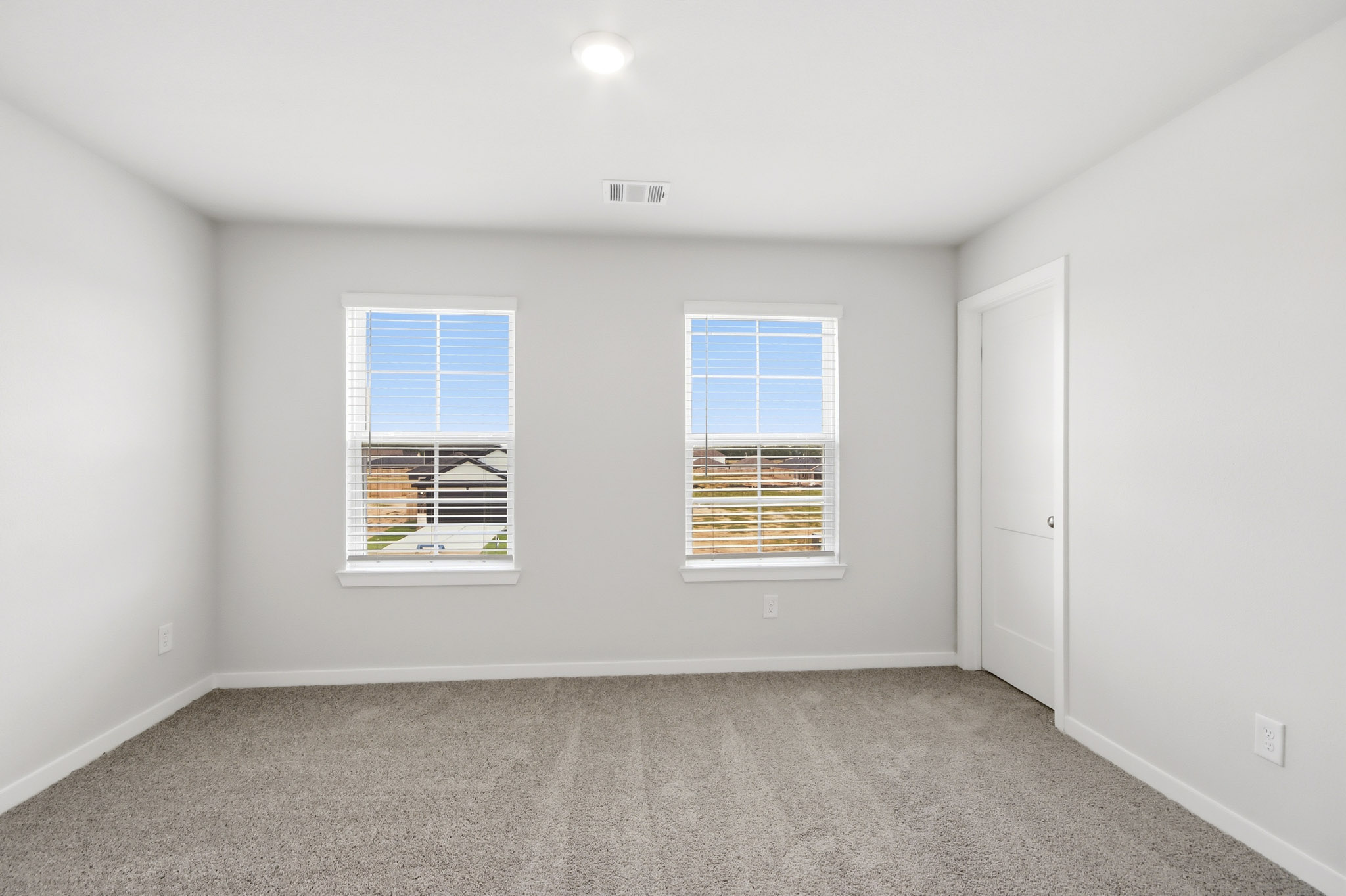 A room with a window and a door.