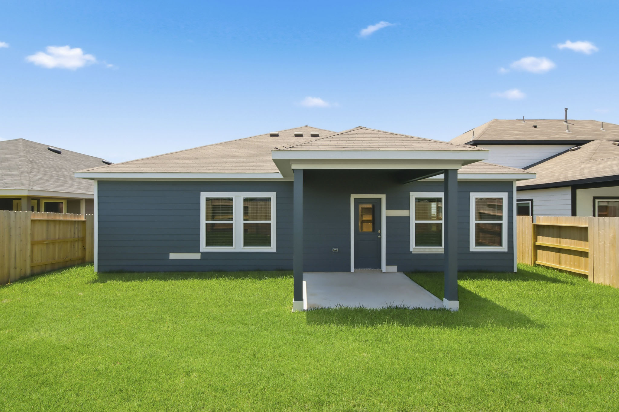 A house with a fence and grass.