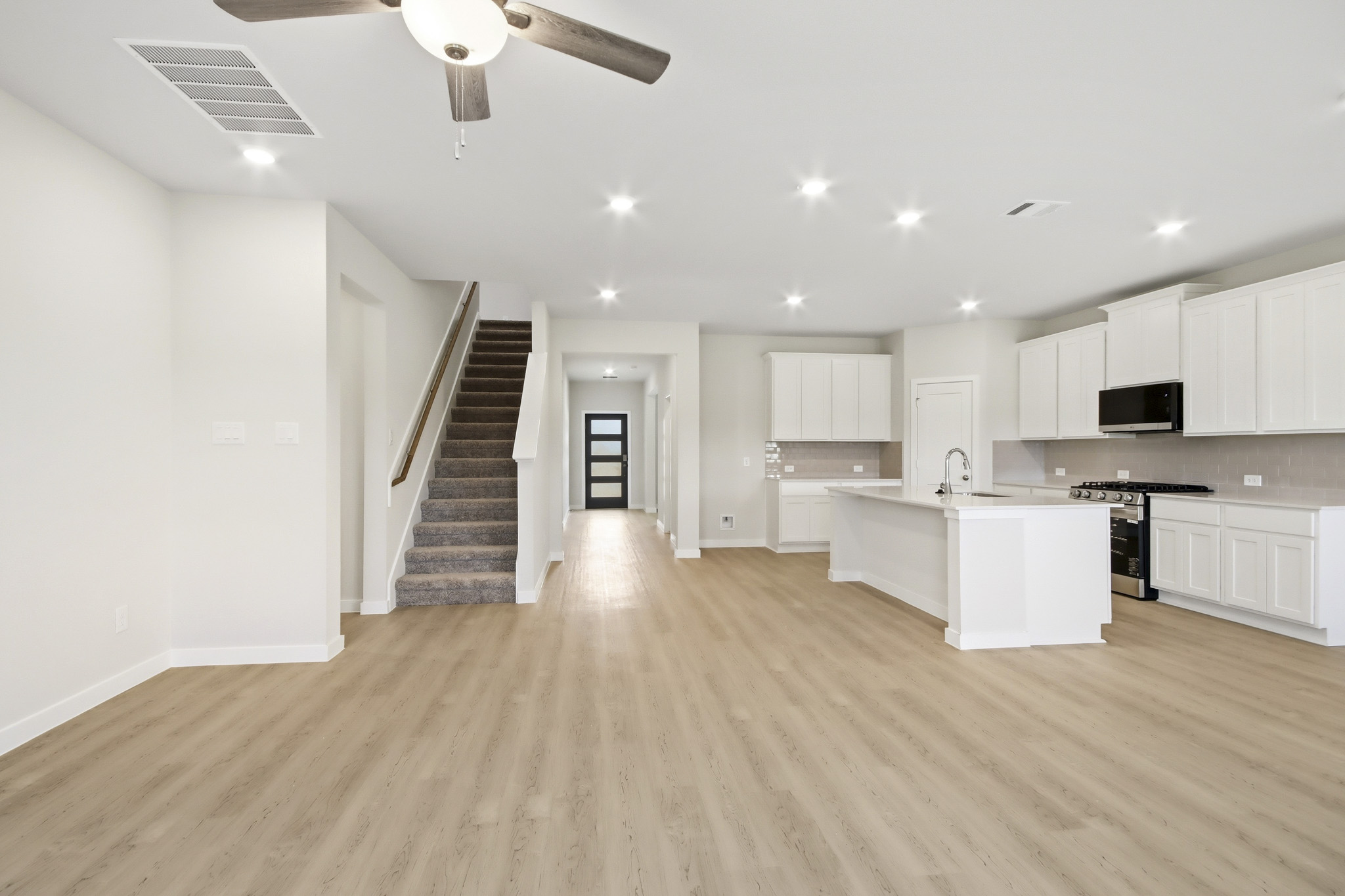 A large kitchen with white cabinets.