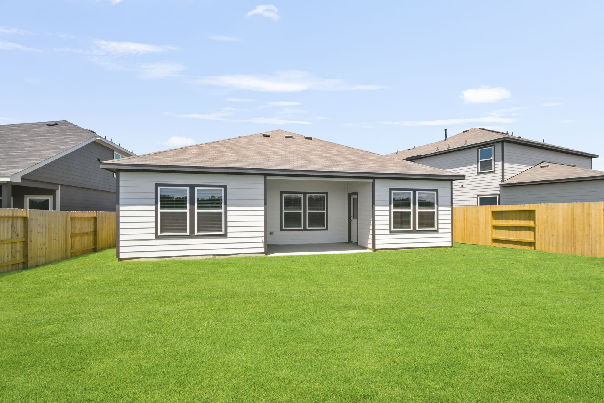 A house with a fence and grass.