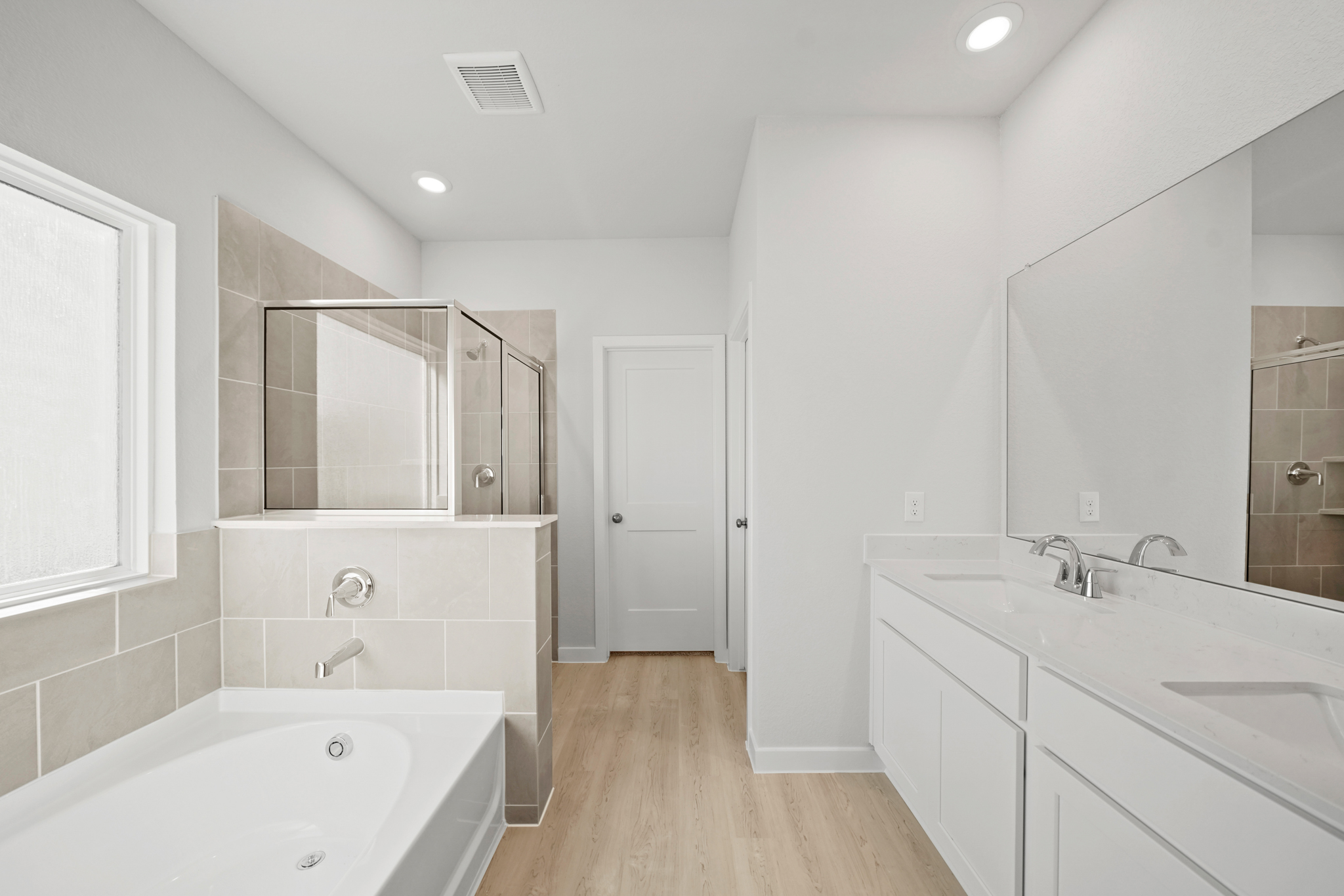 A bathroom with white cabinets.