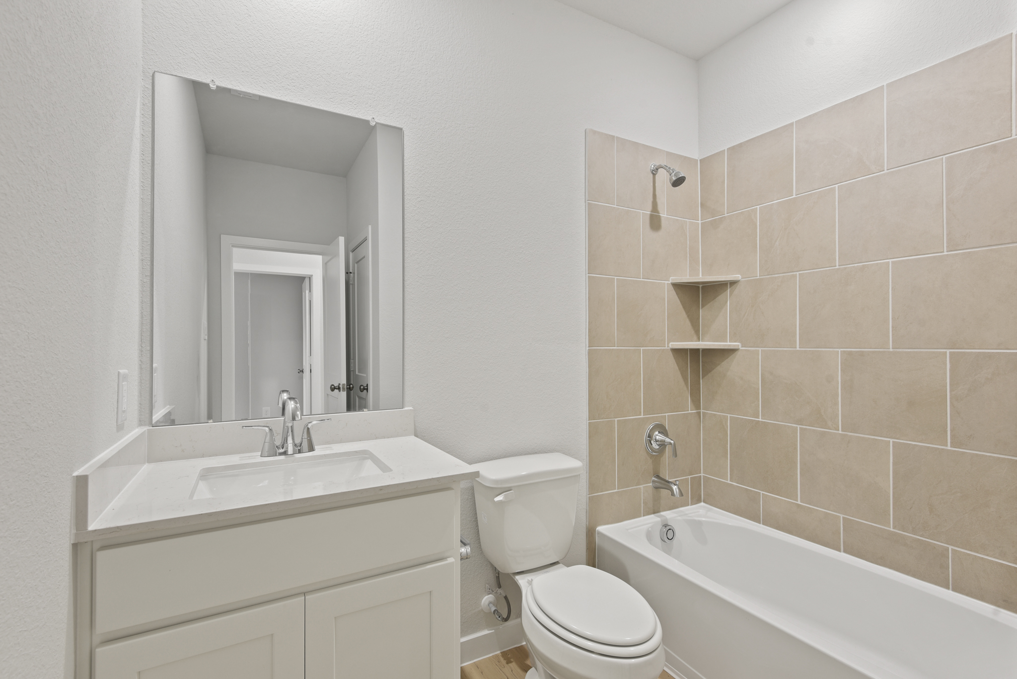 A bathroom with a tub sink and toilet.