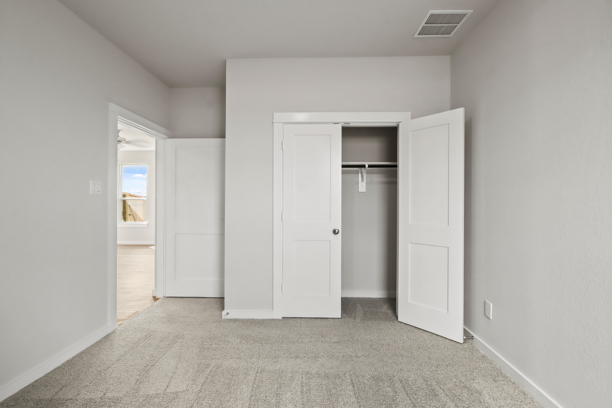 A hallway with white doors.