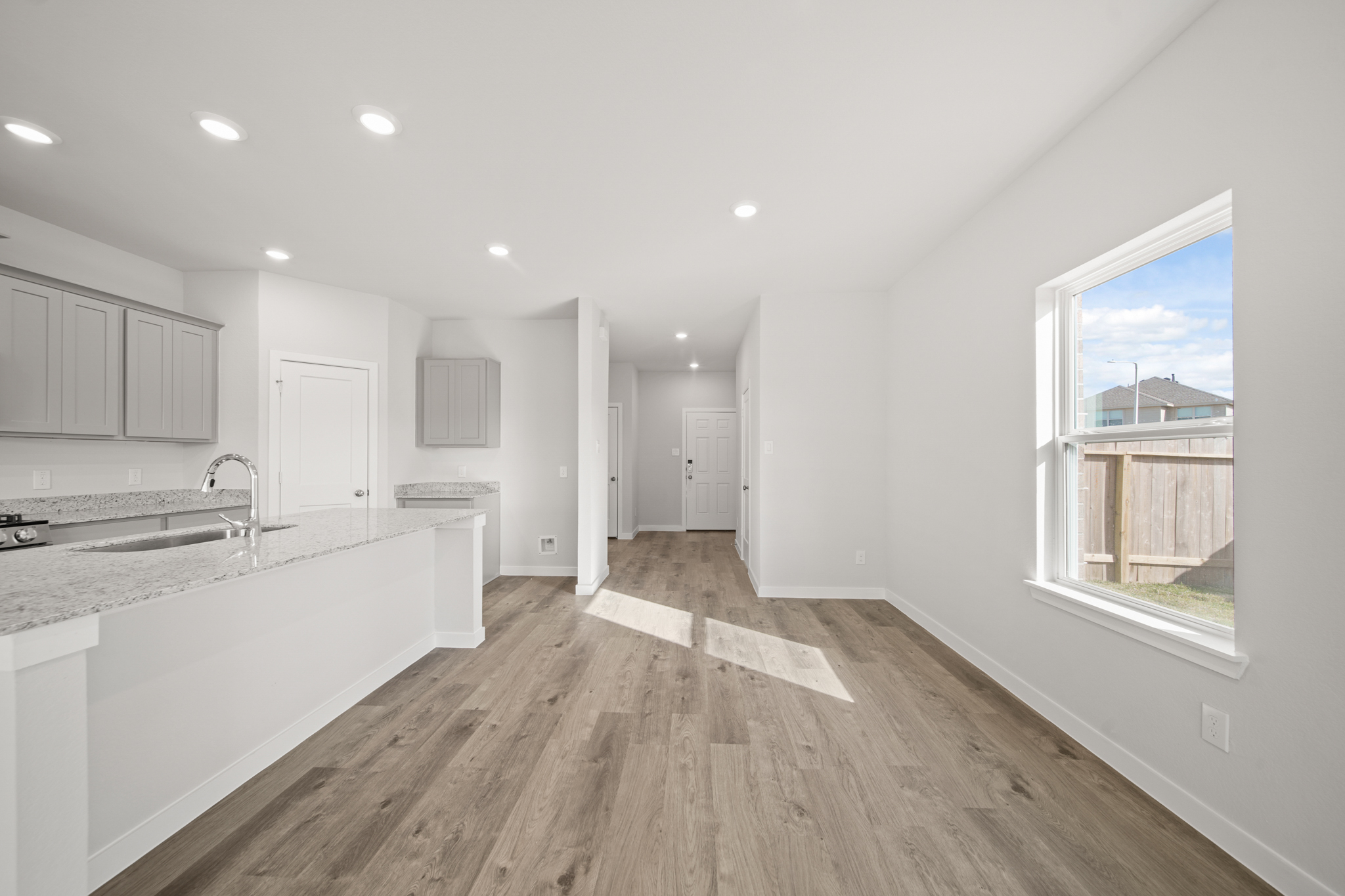 A kitchen with a wood floor.