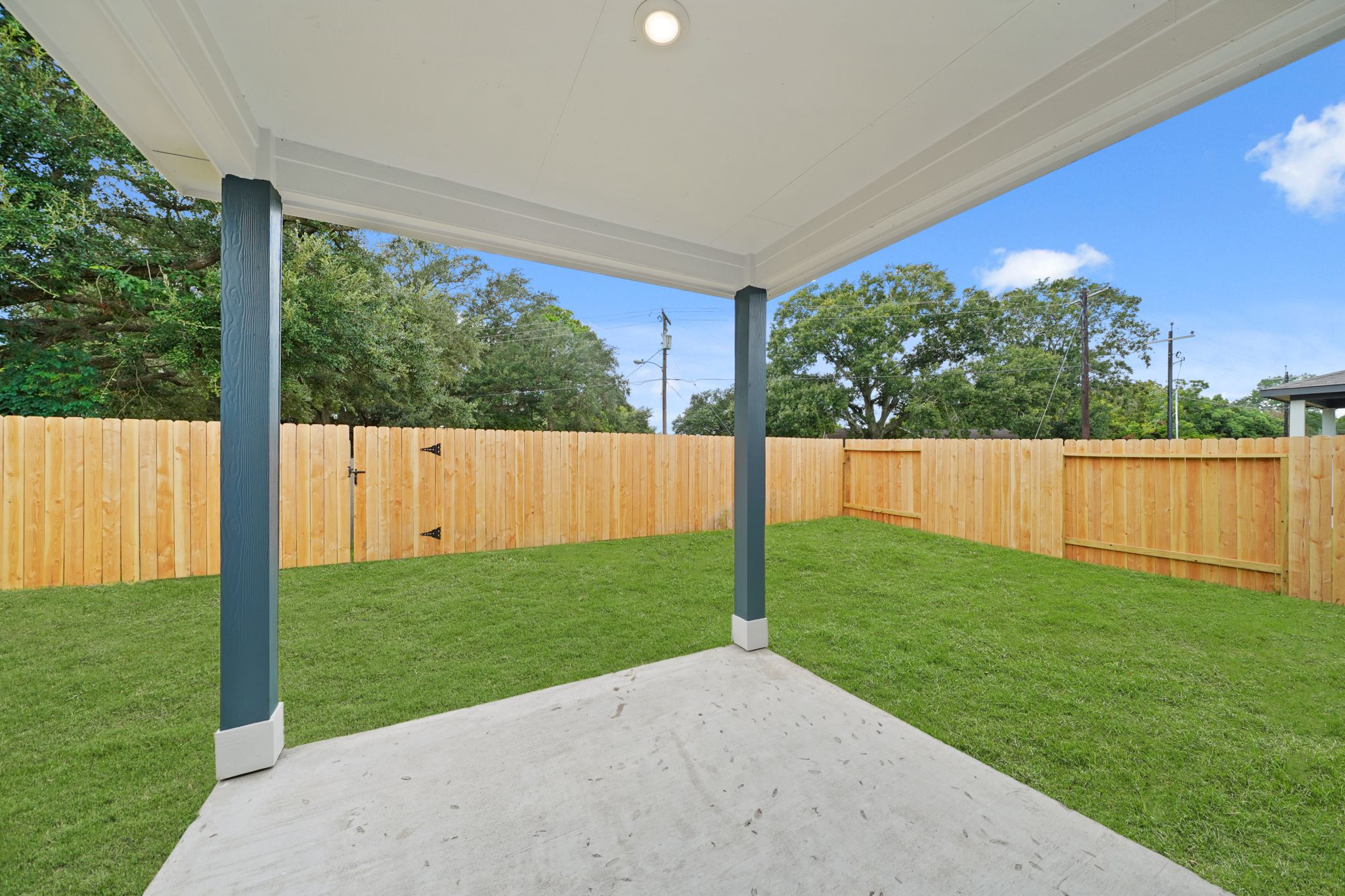 A backyard with a fence.