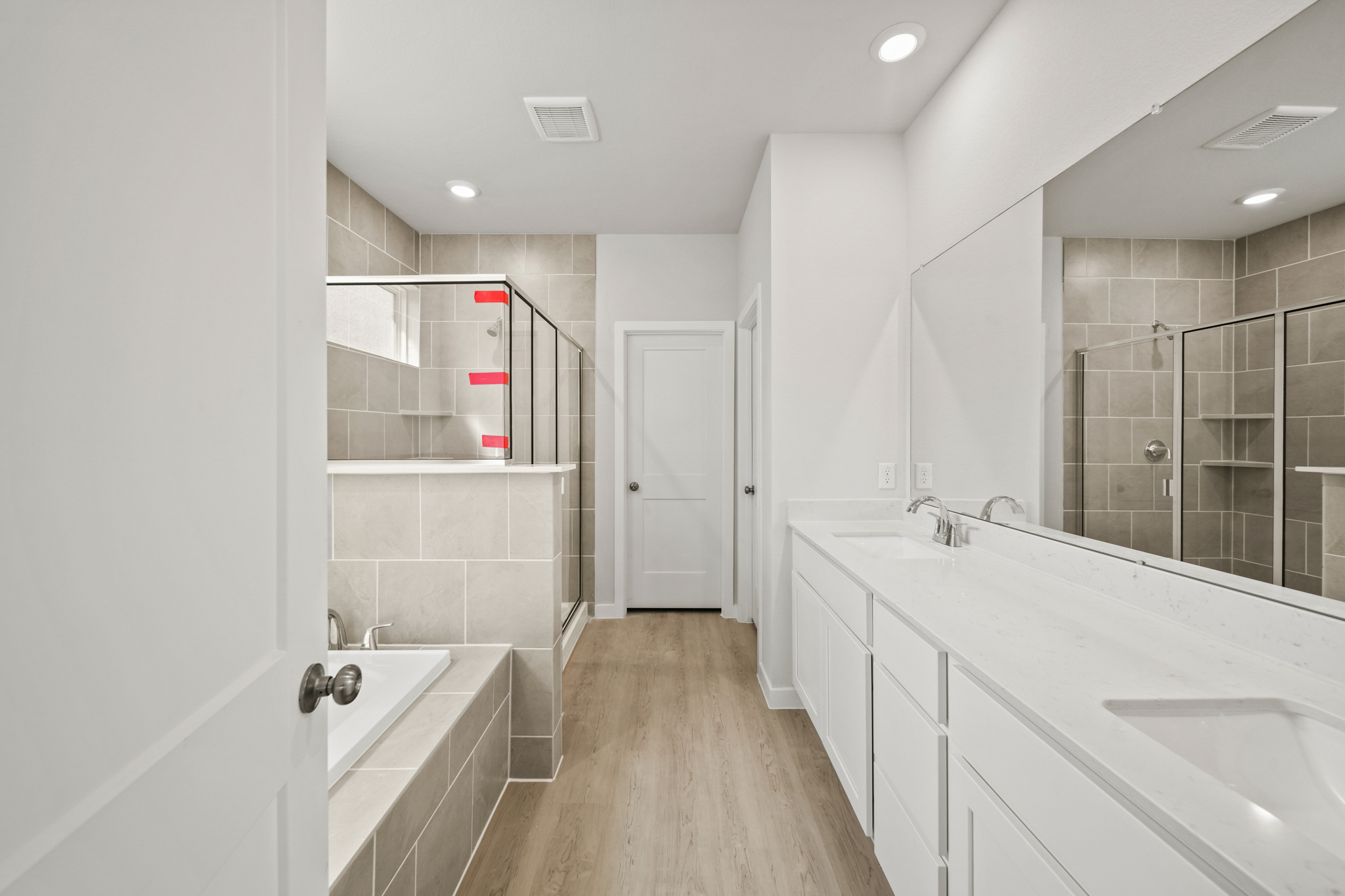 A bathroom with a large mirror.