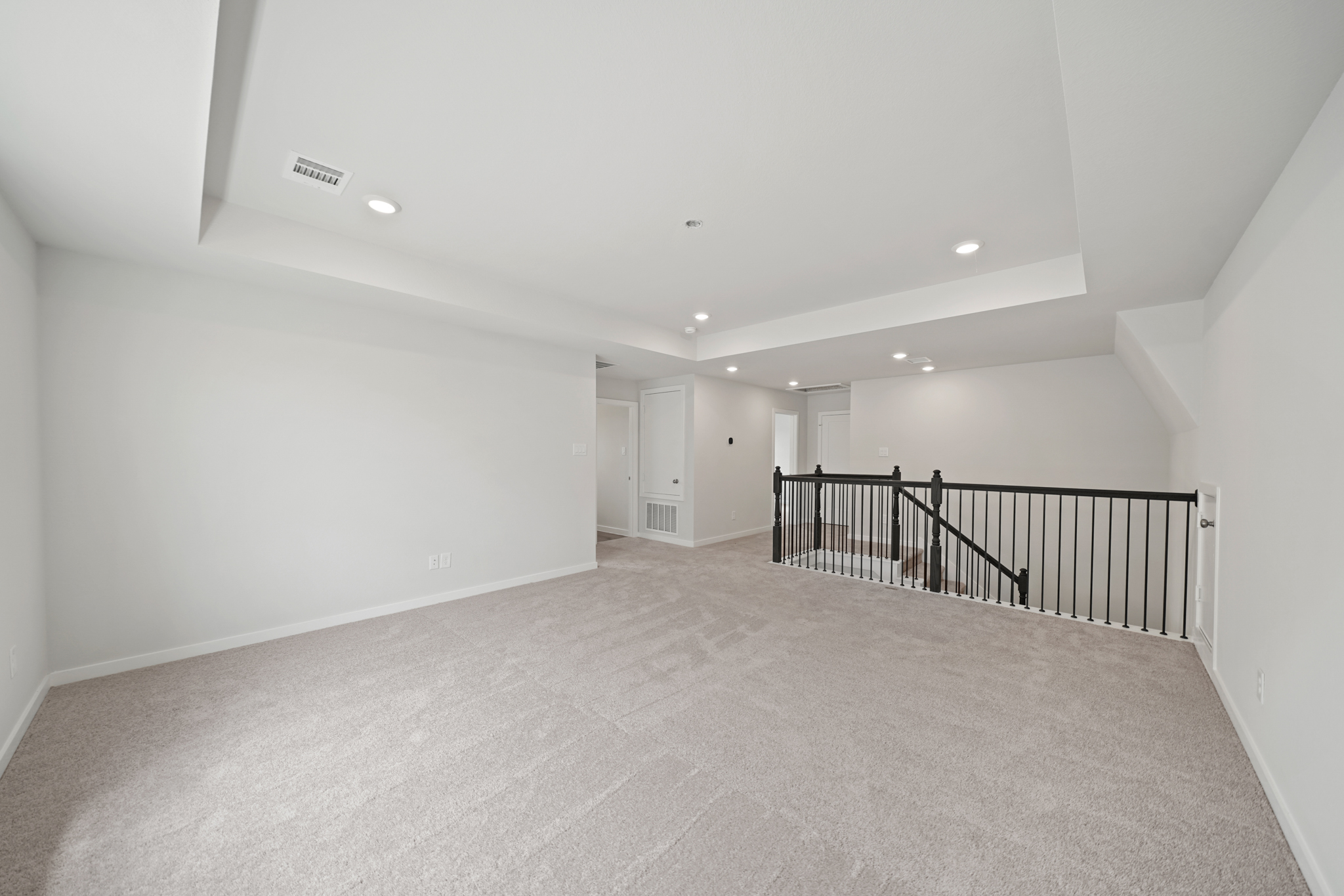 A long hallway with white walls.