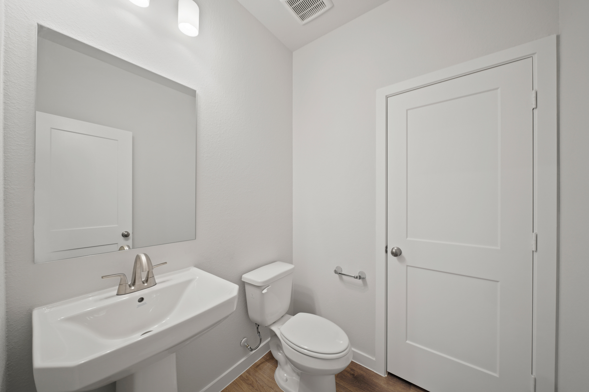 A bathroom with a toilet and sink.