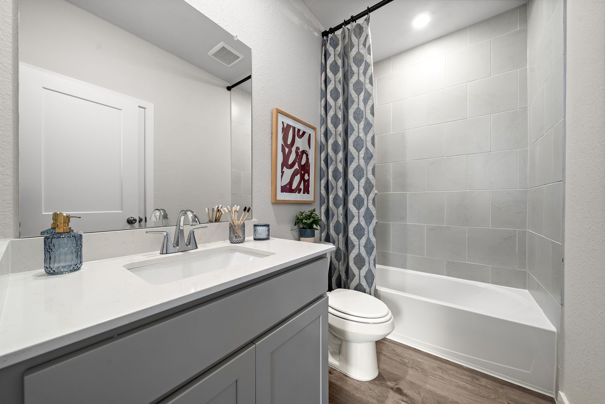A bathroom with a tub sink and toilet.