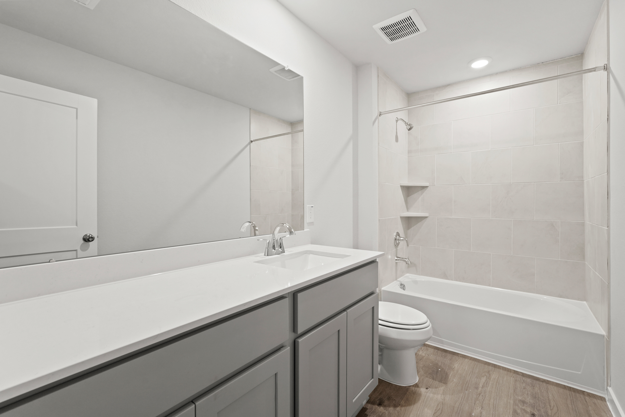 A bathroom with a tub sink and toilet.