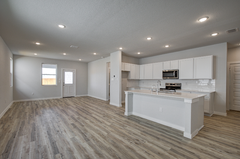 A kitchen with white cabinets.