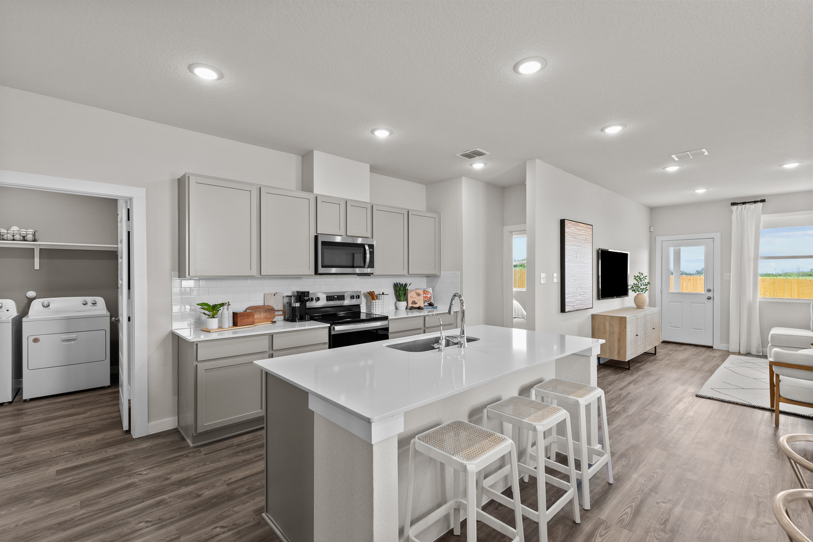A kitchen with white cabinets.